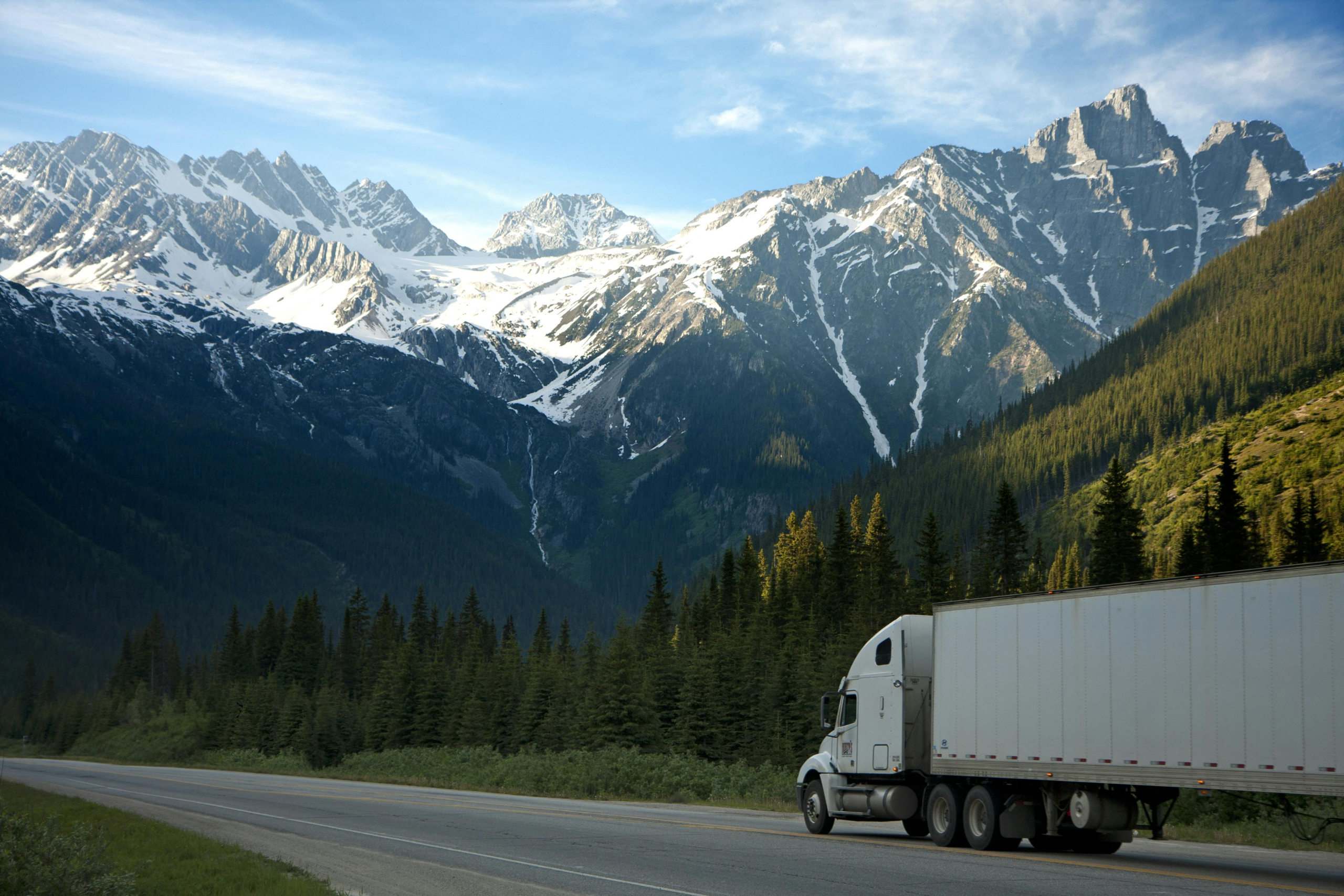 Freight transport within a wider supply chain, illustrating indirect value-chain impacts associated with Scope 3 emissions.